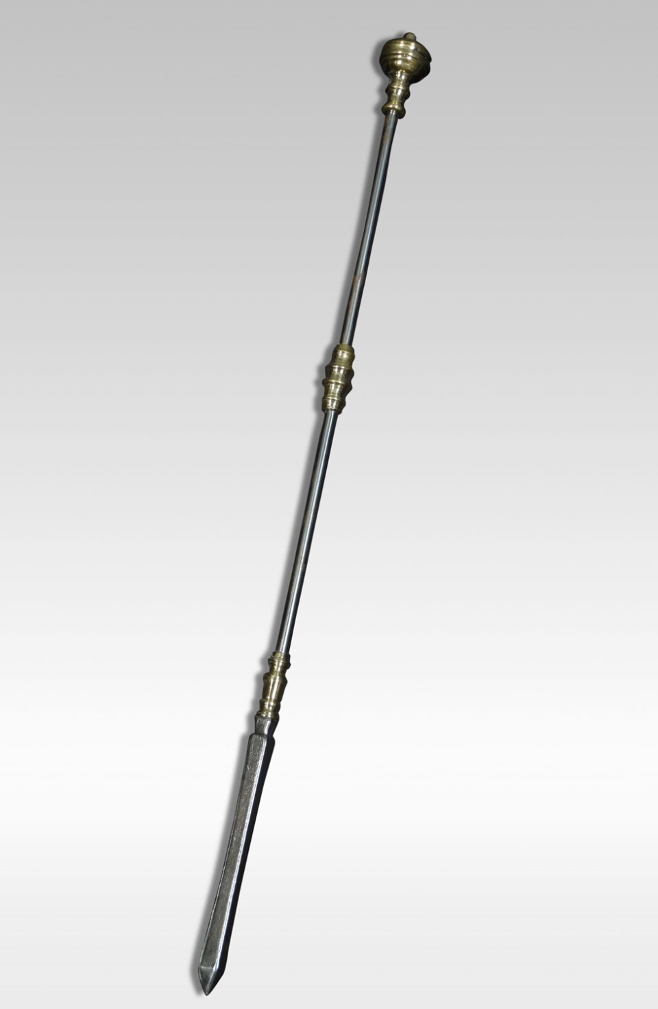 A Victorian steel and brass poker