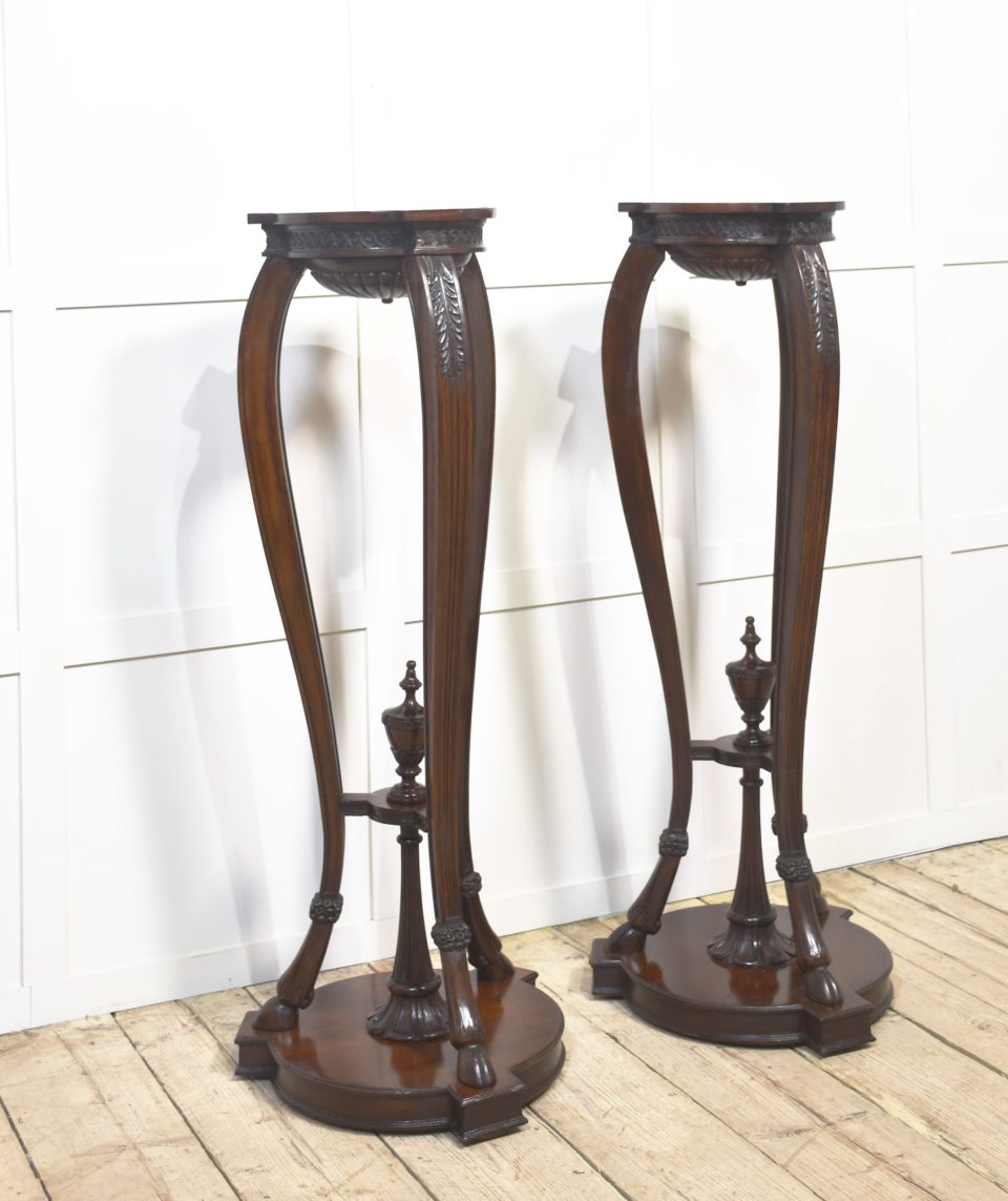 Pair of carved mahogany stands