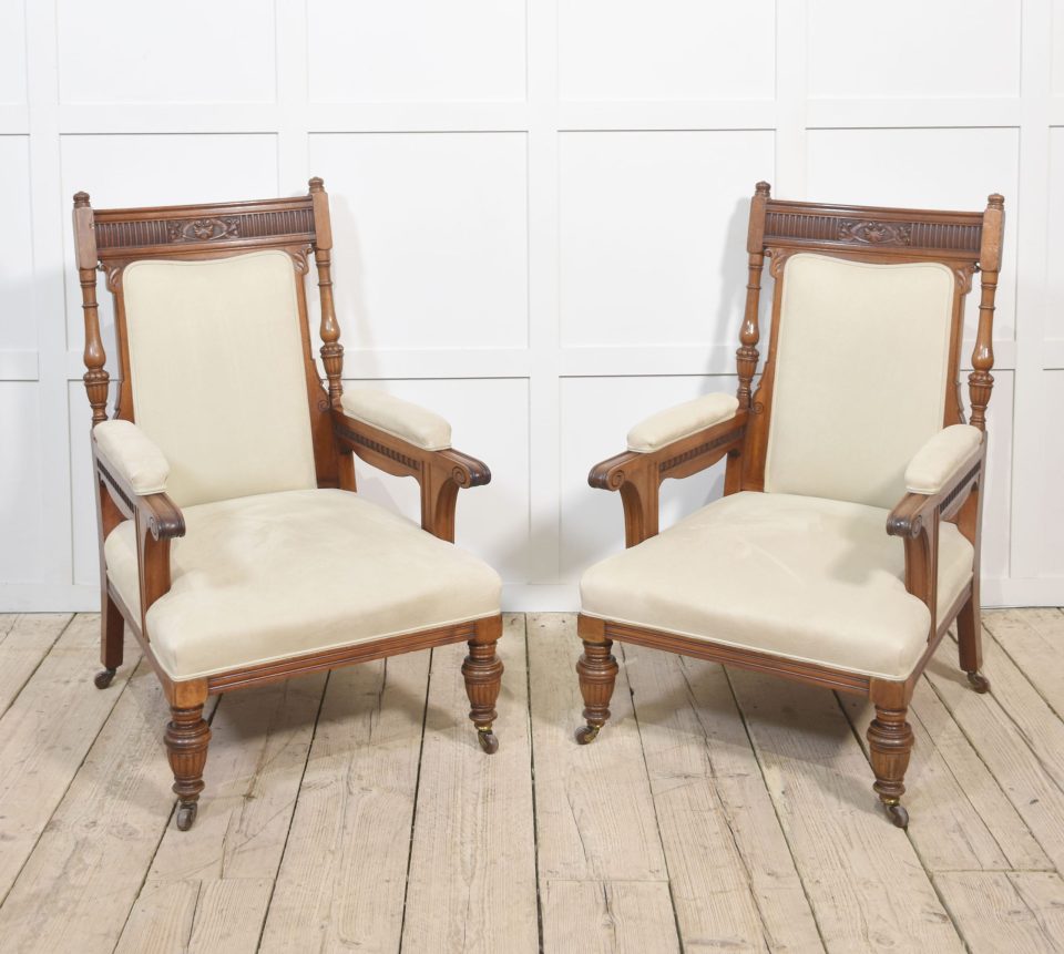 Pair of walnut upholstered library armchairs