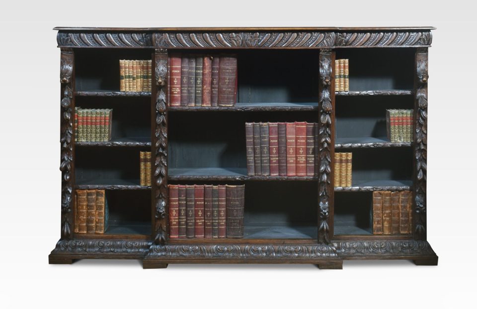 Carved oak breakfront open bookcase