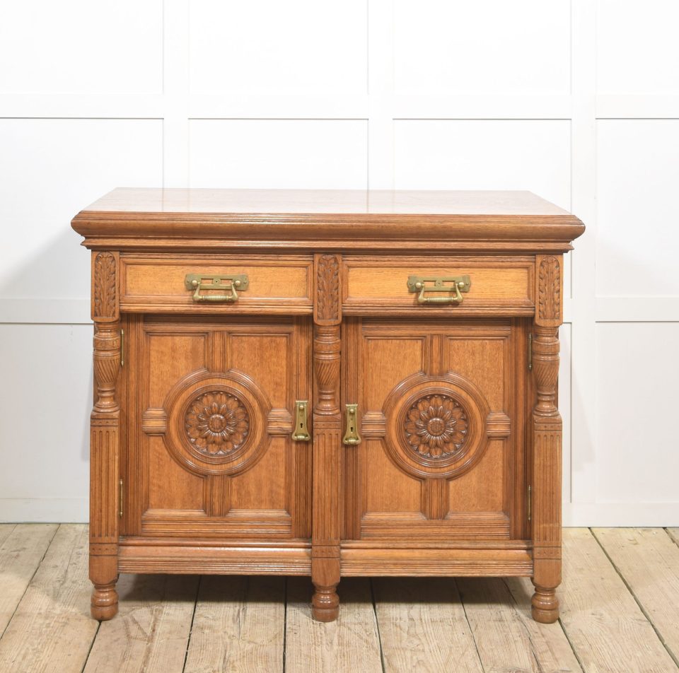 Carved oak two door sideboard by Maple and Co