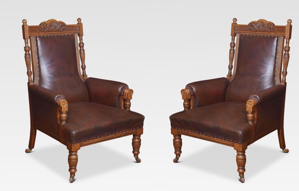 Pair of oak leather upholstered library armchairs